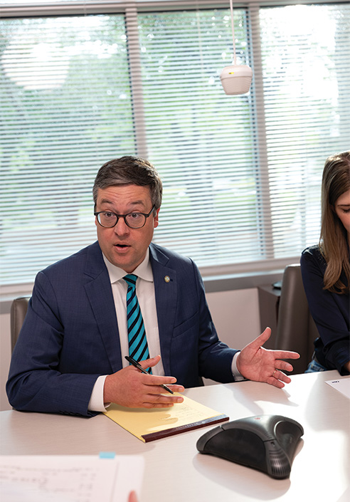 Dane Scalise meeting with a New Hanover County constituent at his desk